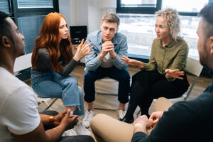 friendly multiethnic business team share ideas during brainstorming on background of window.