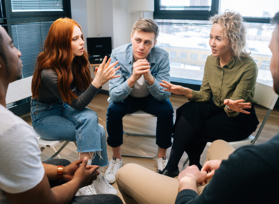 friendly multiethnic business team share ideas during brainstorming on background of window.